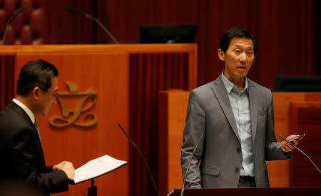 Newly-elected lawmaker Edward Yiu reads from his smartphone while taking oath at the Legislative Council in Hong Kong, China October 12, 2016. REUTERS/Bobby Yip