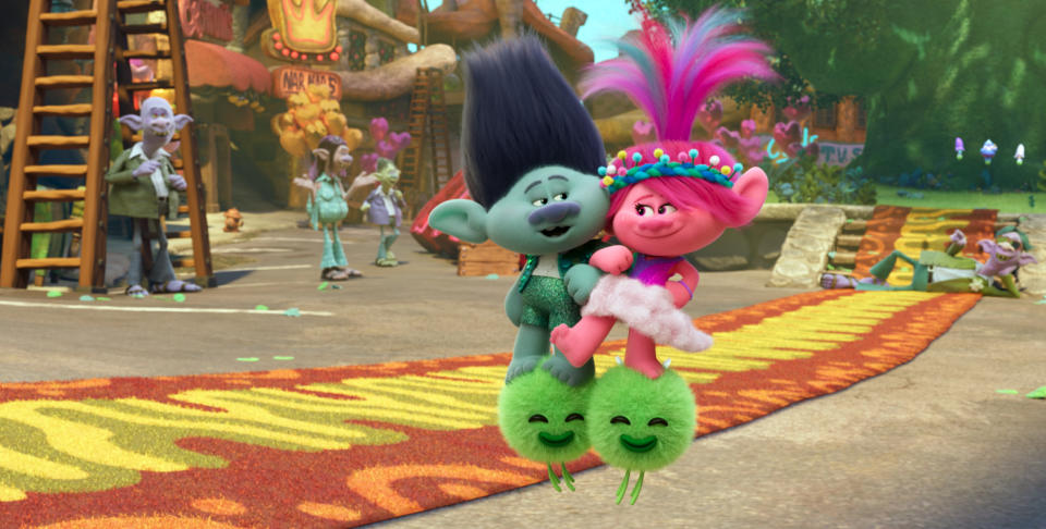 This image released by DreamWorks Animation shows the characters Branch voiced by Justin Timberlake, center left, and Queen Poppy voiced by Anna Kendrick, center right, in a scene of the animated film “Trolls Band Together.” (DreamWorks Animation via AP)