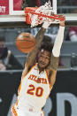 Atlanta Hawks' John Collins dunks the ball in the first half of an NBA basketball game against the Cleveland Cavaliers, Tuesday, Feb. 23, 2021, in Cleveland. (AP Photo/Tony Dejak)