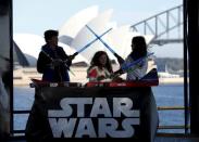 Caleb (L-R), Kayley and Annie Bratayley from the United States participate in a live internet unboxing event to reveal new light saber toys from the film "Star Wars - The Force Awakens" in Sydney, September 3, 2015. REUTERS/Jason Reed