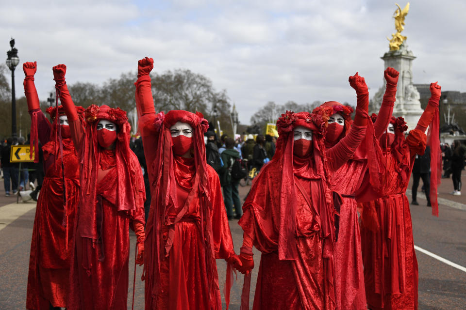 Extinction Rebellion activists perform during a 'Kill the Bill' protest in London, Saturday, April 3, 2021. The demonstration is against the contentious Police, Crime, Sentencing and Courts Bill, which is currently going through Parliament and would give police stronger powers to restrict protests. (AP Photo/Alberto Pezzali)