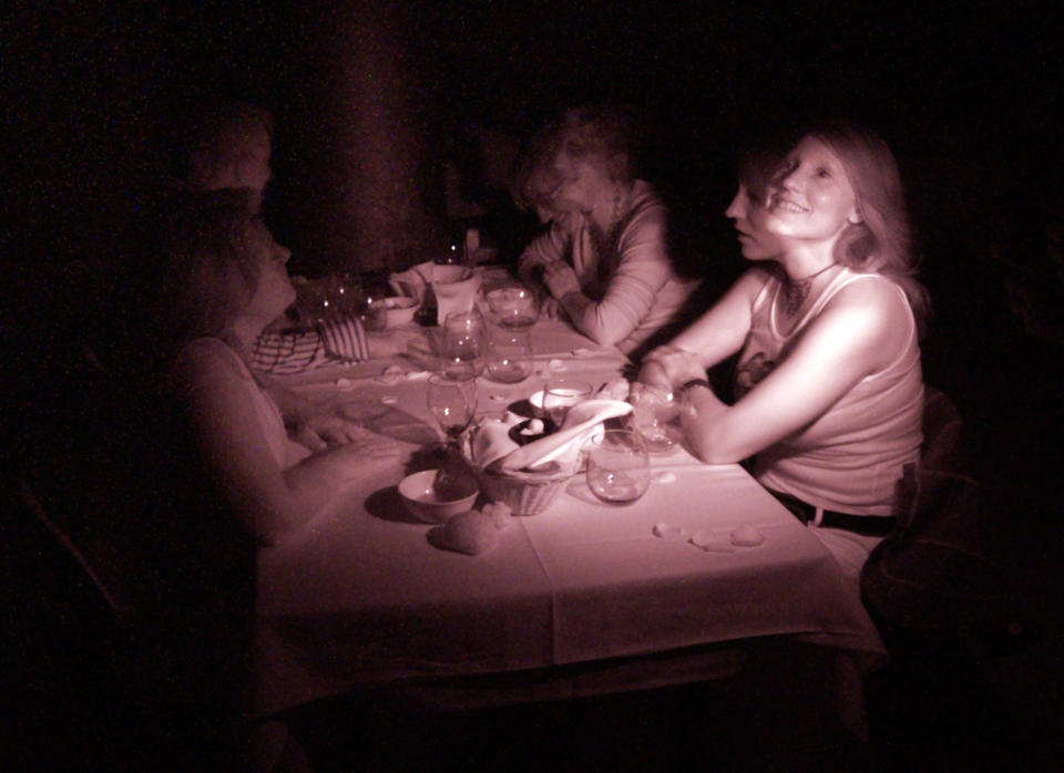 In this false color infrared flashed time exposure image, customers Megan Phares (L), Jamey Titone, (2nd L), Stephanie Wandke (2nd R), and Bonnie Titone (R) experience dining in complete darkness at Opaque in West Hollywood, November 25, 2006. In this weekly dining experience, guests are served a three course gourmet meal in a pitch black dining room by blind waiters. REUTERS/Jason Redmond