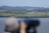 A visitor uses binoculars to see the North Korean side from the unification observatory in Paju, South Korea, Tuesday, May 28, 2024. A rocket launched by North Korea to deploy the country's second spy satellite exploded shortly after liftoff Monday, state media reported, in a setback for leader Kim Jong Un's hopes to operate multiple satellites to better monitor the U.S. and South Korea. (AP Photo/Lee Jin-man)