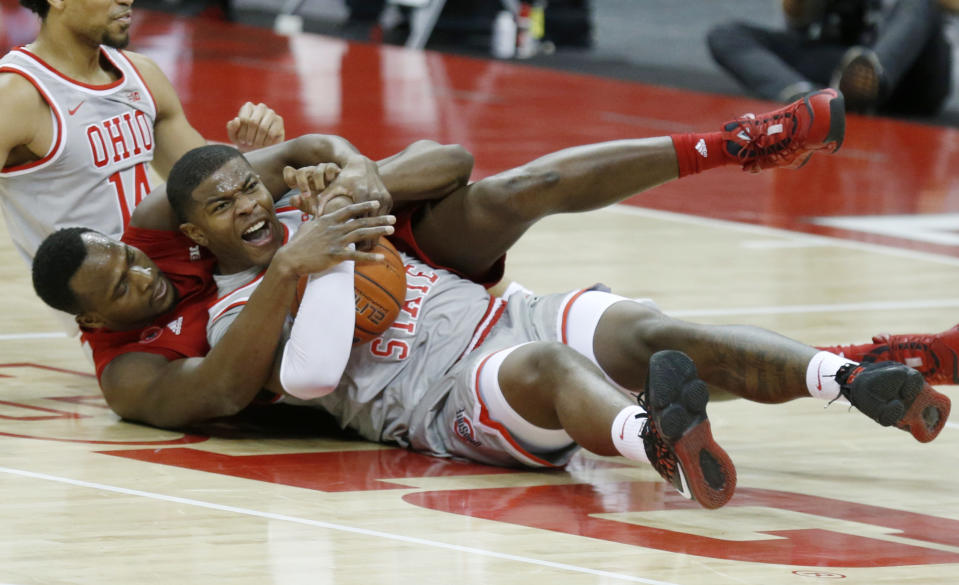 Rutgers forward Mamadou Doucoure, left, works for a loose ball against Ohio State forward E.J. Liddell during the first half of an NCAA college basketball game in Columbus, Ohio, Wednesday, Dec. 23, 2020. (AP Photo/Paul Vernon)