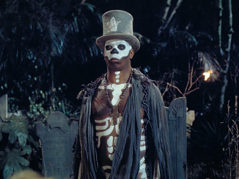 Geoffrey Holder in a top hat and face paint