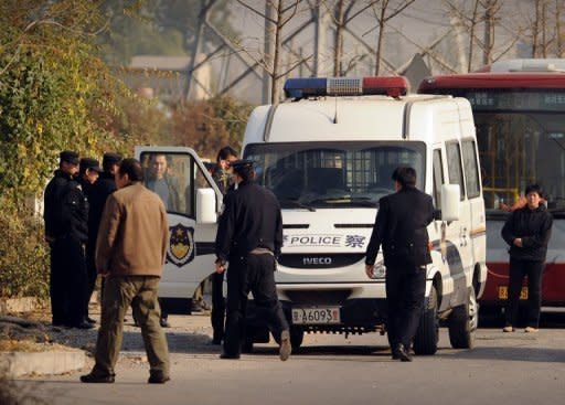 Chinese police near Ai Weiwei's studio in Beijing. The dissident artist has accused Chinese authorities of trying to "crush him" after he was barred from a hearing challenging a multi-million-dollar tax penalty against a firm he founded