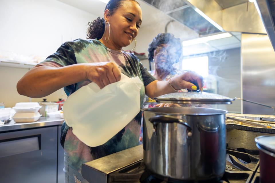 Ashara Feloss uses bottled water for cooking at DJ's One Stop, a lunch place in Plaquemines Parish, La., on Friday, Sept. 29, 2023.