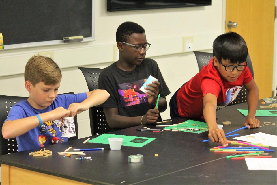 Students in an ExploreHope Summer Science Camp participate in an activity to create a device that can take a core sample from modeling clay.