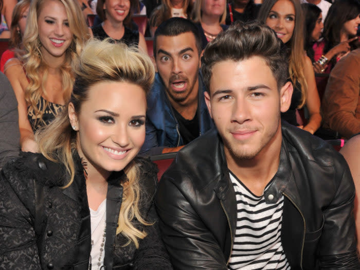 UNIVERSAL CITY, CA - AUGUST 11: (L-R) Musicians Demi Lovato, Joe Jonas, and Nick Jonas attend the 2013 Teen Choice Awards at Gibson Amphitheatre on August 11, 2013 in Universal City, California. (Photo by Kevin Mazur/Fox/WireImage)