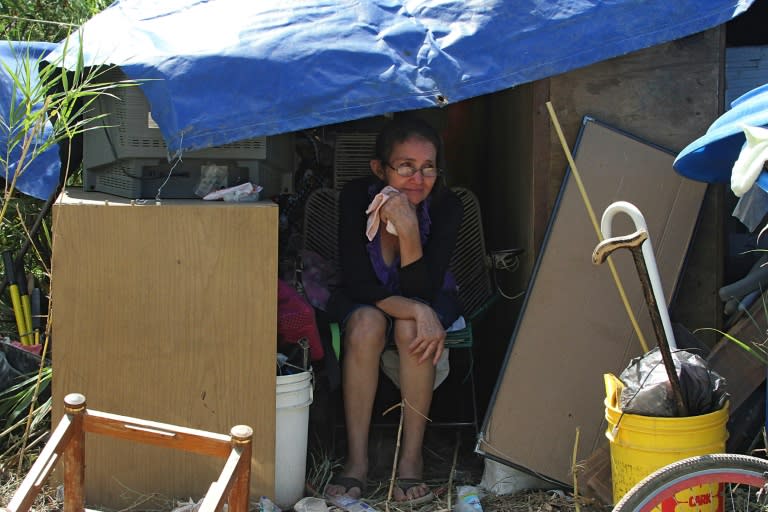 A Colombian woman rests next to her belongings in Cucuta on August 28, 2015, after arriving from Venezuela