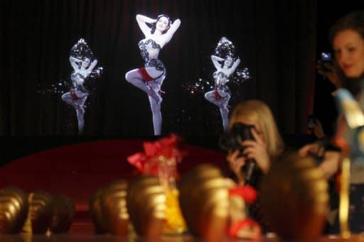 A 3D hologram of a burlesque dancer at a preview of an exhibition by French shoe designer Christian Louboutin showcases 20 years of the famous red-soled shoes at the Design Museum in London