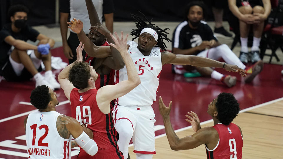 Toronto Raptors' Precious Achiuwa (5) battles for a rebound. (AP Photo/John Locher)