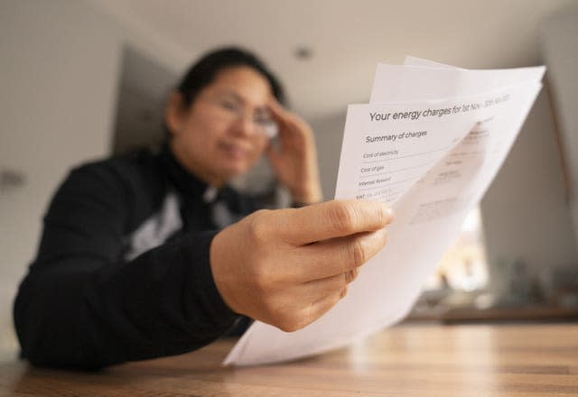 A person holding an energy bill.