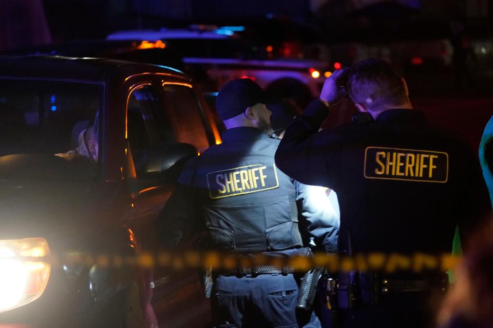 Law enforcement personnel on Monday are pictured patrolling the scene after a shooting in Half Moon Bay, Calif. Officials said seven people were killed in two related shootings Monday at a mushroom farm and a trucking firm in a coastal community south of San Francisco.