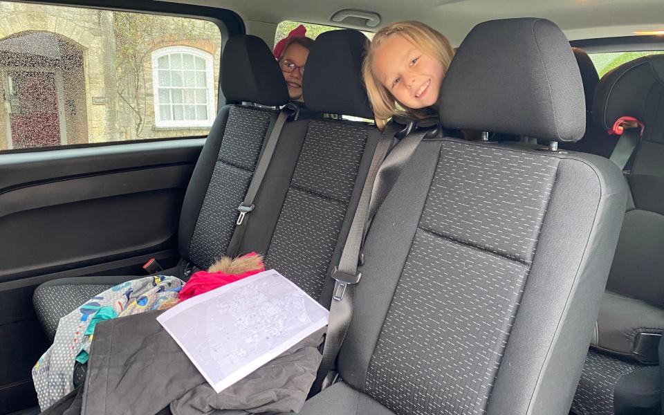 Kids sit in the backseat of the Mercedes e-Vito