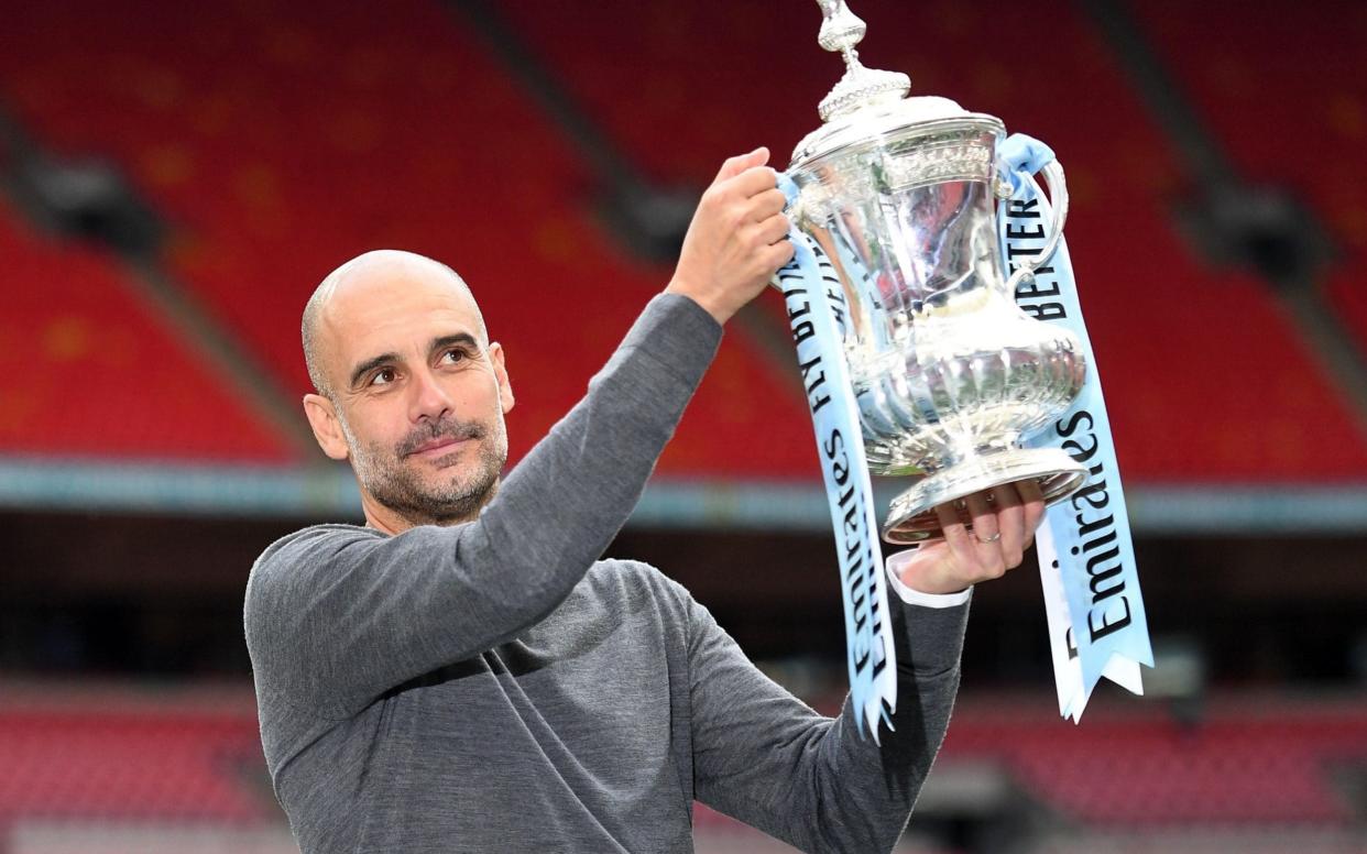 Pep Guardiola became the first manager to win a domestic treble in England - AFP