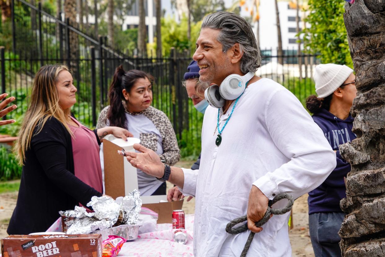 Will Sens helps with snack distribution for Valentine’s Day in downtown Los Angeles. Sens, 45, is formerly homeless and lived at The LA Grand, a temporary hotel shelter that is part of Mayor Karen Bass' Project Roomkey. After living there for two years, Sens now has a studio apartment he shares with a roommate.