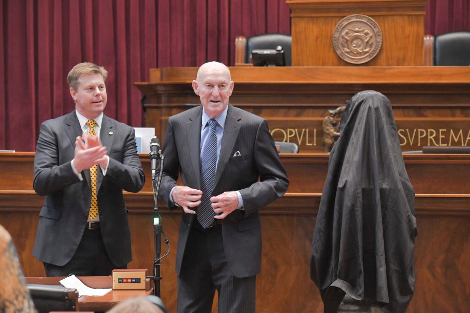 Former Missouri basketball coach Norm Stewart (center) speaks during his induction ceremony into the Hall of Famous Missourians while House Speaker Dean Plocher (left) applauds Wednesday in Jefferson City.