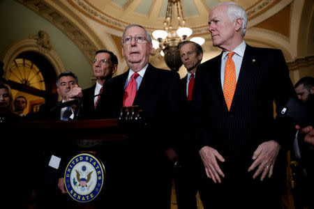 Senate Majority Leader Mitch McConnell, accompanied by Sen. John Cornyn (R-TX), Sen. John Thune (R-SD), Sen. John Barrasso (R-WY) and Sen. Cory Gardner (R-CO), speaks with reporters following the party luncheons on Capitol Hill in Washington, U.S. January 23, 2018. REUTERS/Aaron P. Bernstein