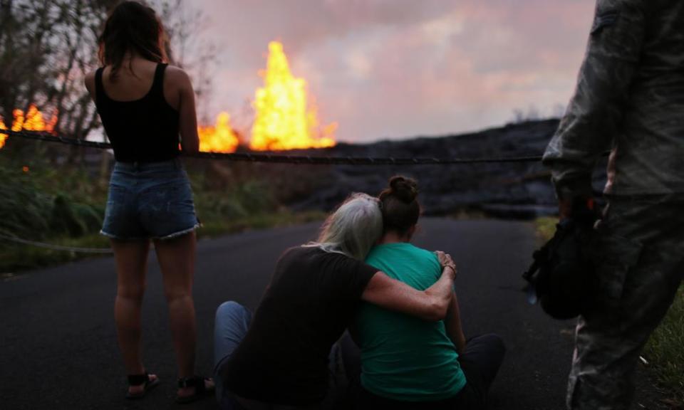 Residents watch lava erupting from a Kilauea volcano fissure in Leilani Estates, on Hawaii’s Big Island, on 23 May 2018 in Pahoa, Hawaii.