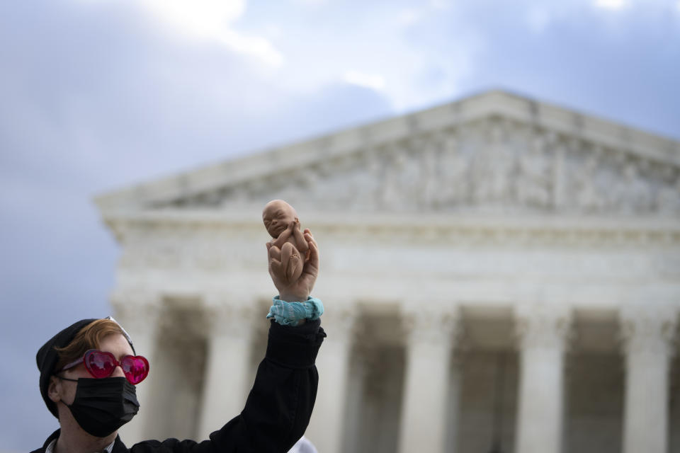 An anti-abortion demonstrator protests outside the Supreme Court.