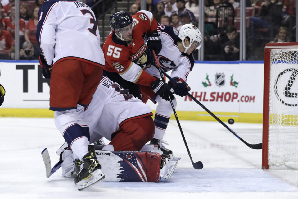 Florida Panthers center Noel Acciari (55) and Columbus Blue Jackets left wing Sonny Milano, right, fight for the puck during the second period of an NHL hockey game, Saturday, Dec. 7, 2019, in Sunrise, Fla. (AP Photo/Lynne Sladky)