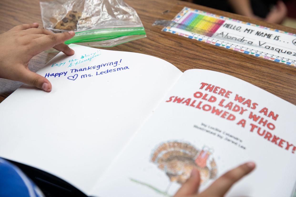 Third grade students receive a free Thanksgiving book from staff and family at Sam Houston Elementary on Thursday, Nov. 16, 2023, in Corpus Christi, Texas.