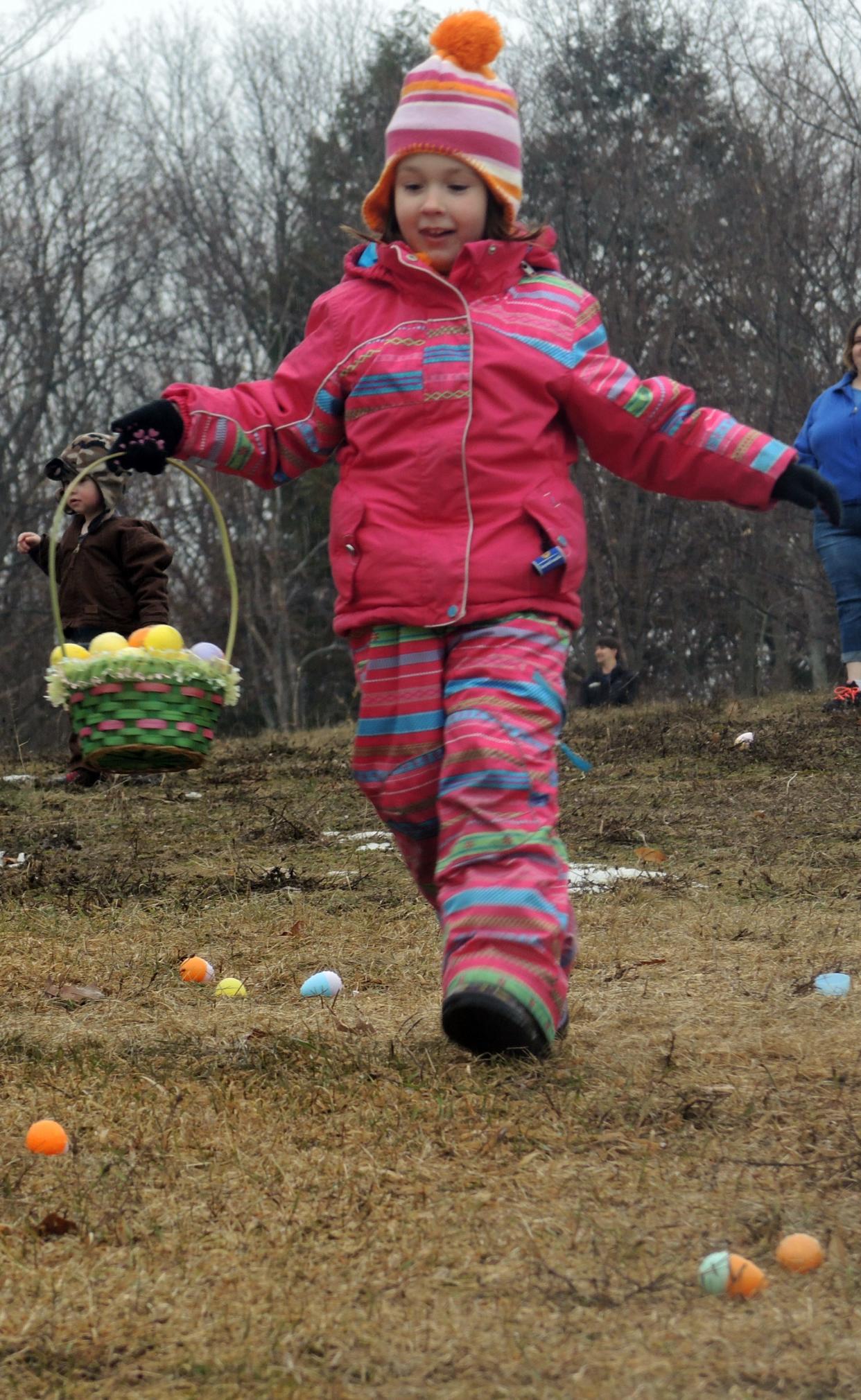 Juniper Rodham, 7, of Harbor Springs runs toward more Easter eggs during the 2021 Easter egg hunt in Harbor Springs.