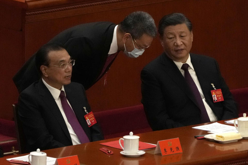 Chinese Premier Li Keqiang, left, and President Xi Jinping attend the closing ceremony of the 20th National Congress of China's ruling Communist Party at the Great Hall of the People in Beijing, Saturday, Oct. 22, 2022. (AP Photo/Andy Wong)