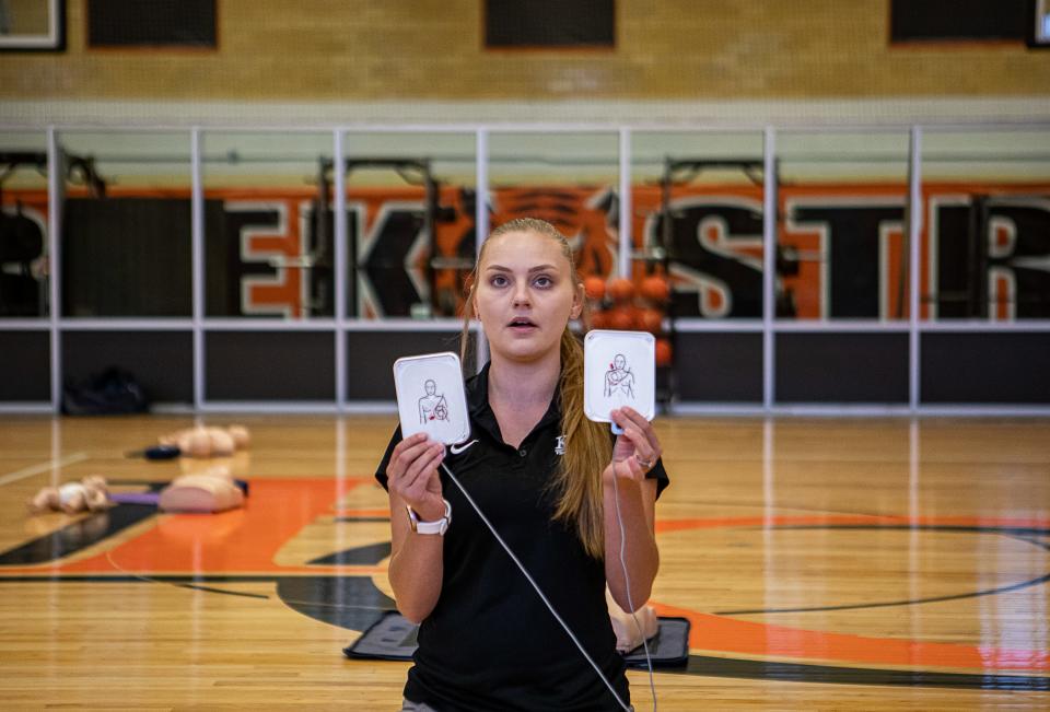 Alysha Buehler, Western High School athletic trainer, demonstrated the use of an AED device during training at Fern Creek High School. The training was part of Jefferson County Public Schools' annual fall clinic, which reviewed topics like mental health, nutrition and first-aid training. July 7, 2023 
