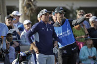 Rickie Fowler, center, looks to the fairway before hitting from the 13th tee during the second round of The American Express golf tournament on the Nicklaus Tournament Course at PGA West on Friday, Jan. 17, 2020, in La Quinta, Calif. (AP Photo/Marcio Jose Sanchez)