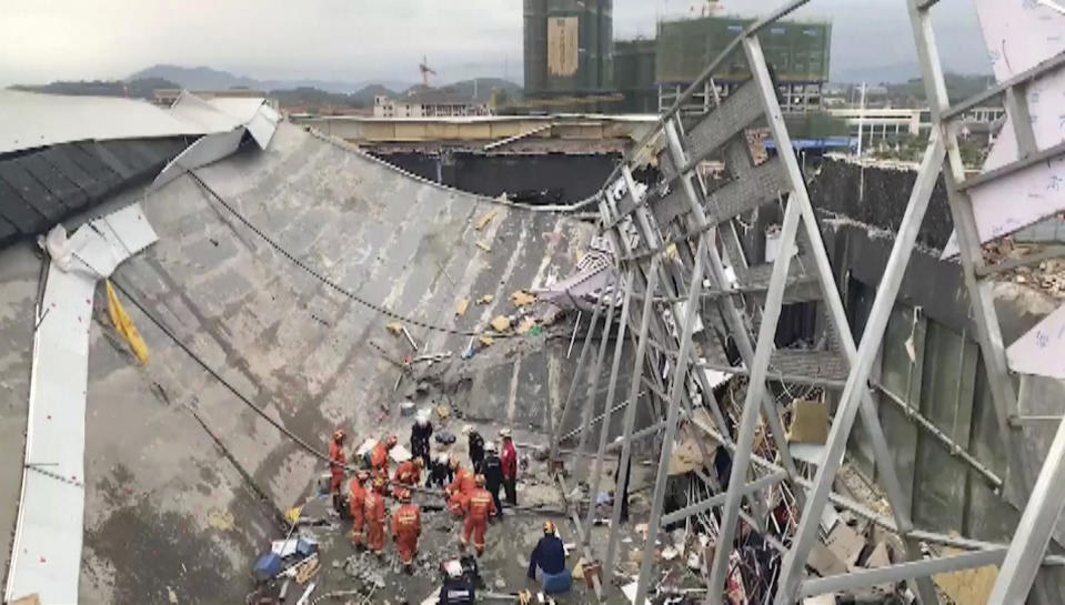 In this image from video, rescuers try to find survivors at the site where a building collapsed in Baise City, Guangxi Zhuang Autonomous Region, south China, Monday, May 20, 2019. Framework surrounding a bar gave way on Monday, trapping or injuring almost 100 people. (CCTV via AP)