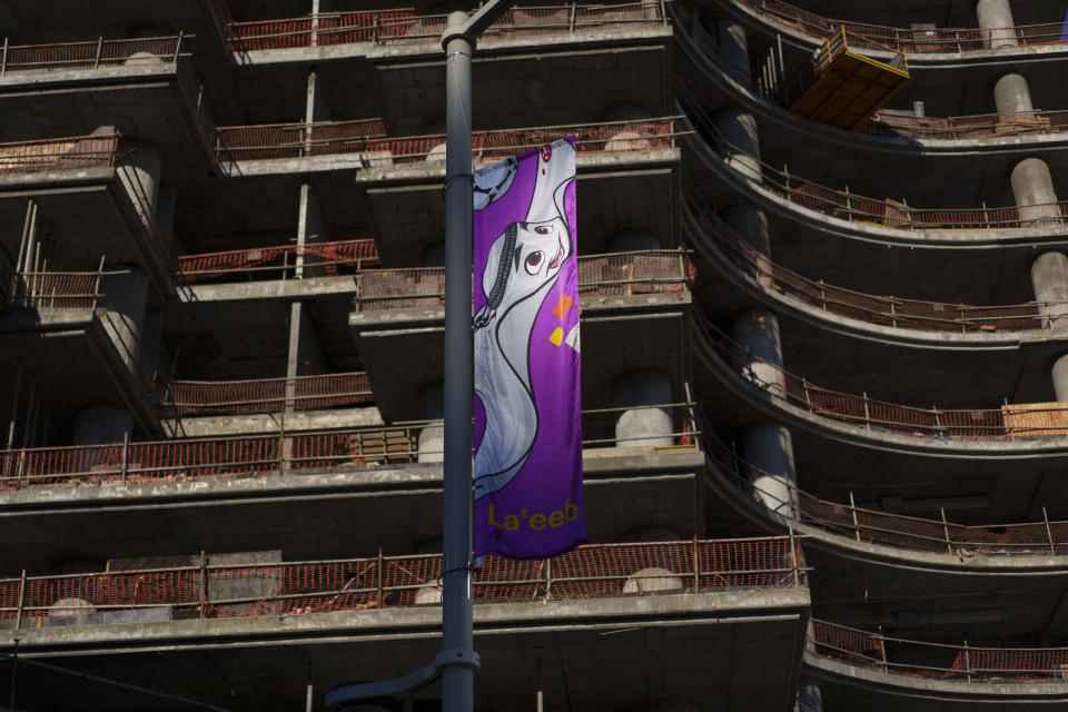 A flag hangs from a building under construction in Lusail downtown, Qatar, Thursday, Nov. 24, 2022. (AP Photo/Pavel Golovkin)