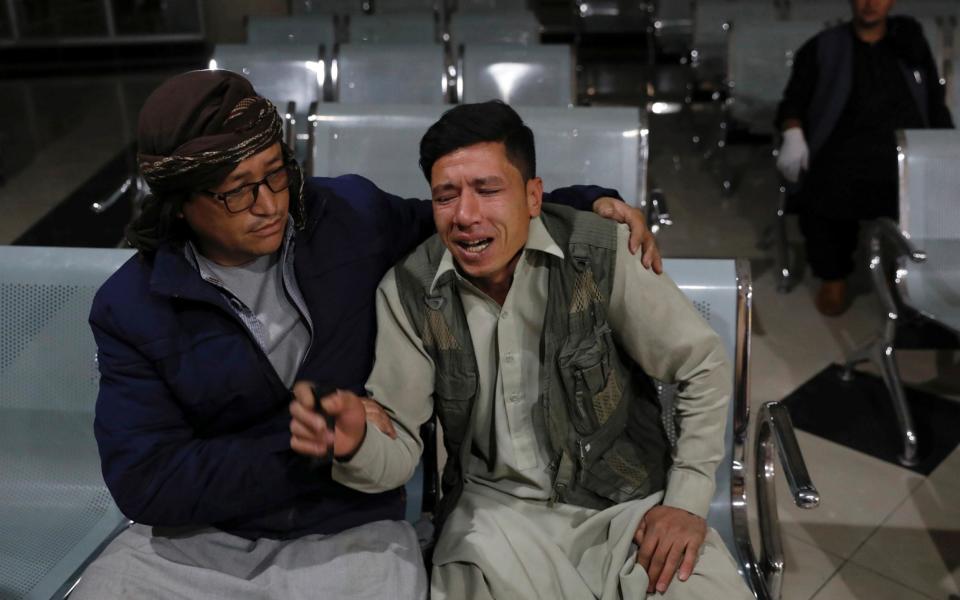 Man who lost his brother mourns at a hospital after a suicide bombing in Kabul - REUTERS