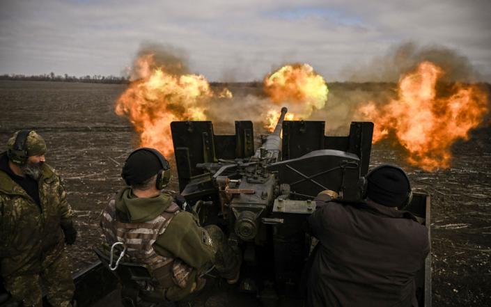 Ukrainian servicemen fire with a S60 anti-aircraft gun at Russian positions near Bakhmut - ARIS MESSINIS/AFP