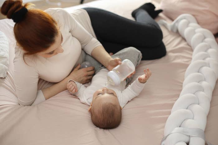 woman bottle feeding her baby