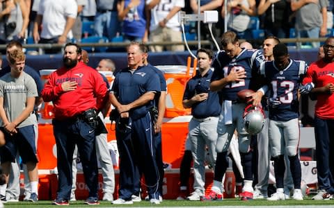 New England Patriots quarterback Tom Brady (12) stands during the anthem - Credit: USA Today