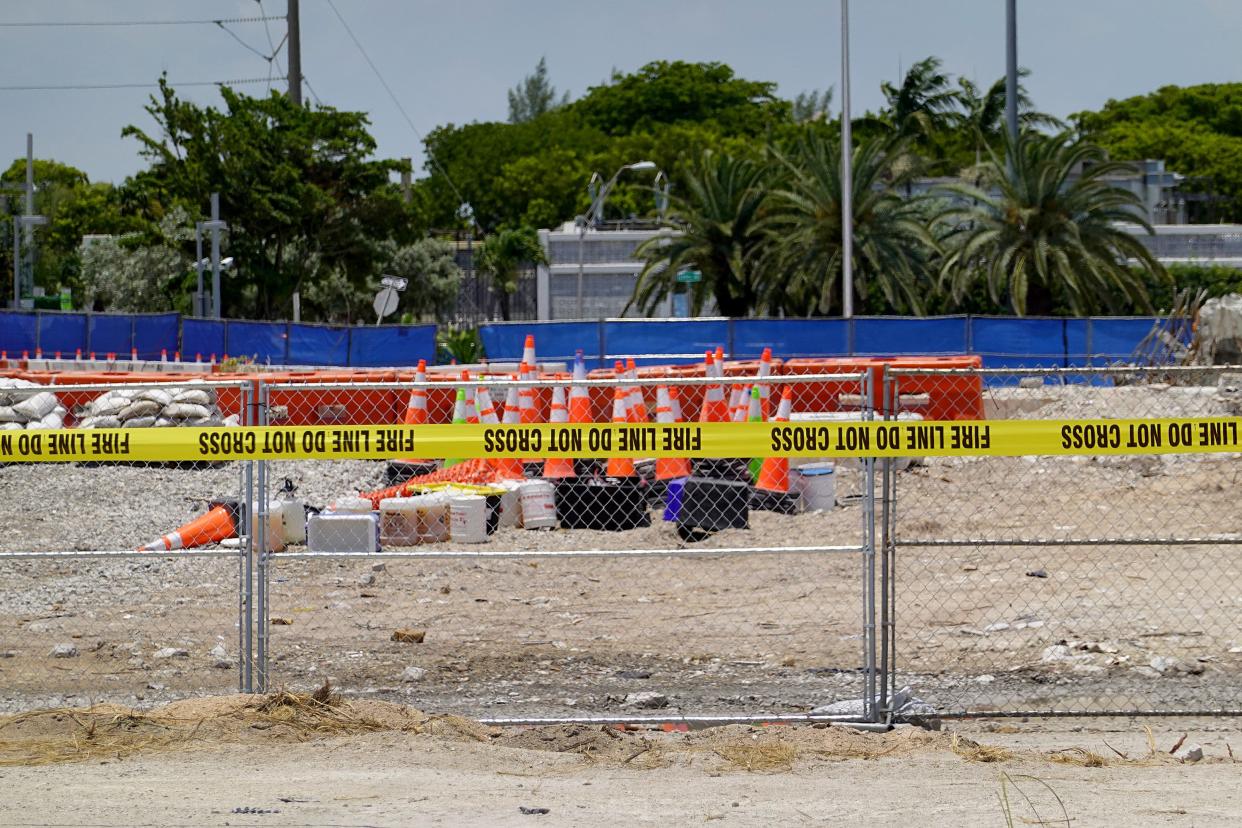 Fire department tape keeps people out of the empty lot where the collapsed 12-story Champlain Towers South condo building once stood on July 27, 2021 in Surfside, Florida.