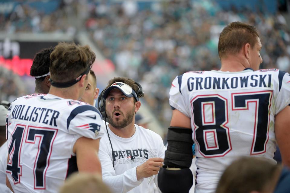 New England Patriots tight ends coach Nick Caley, center, talks with tight ends Jacob Hollister (left) and Rob Gronkowski on the sideline during the first half against the Jaguars, Sunday, Sept. 16, 2018, in Jacksonville, Fla.