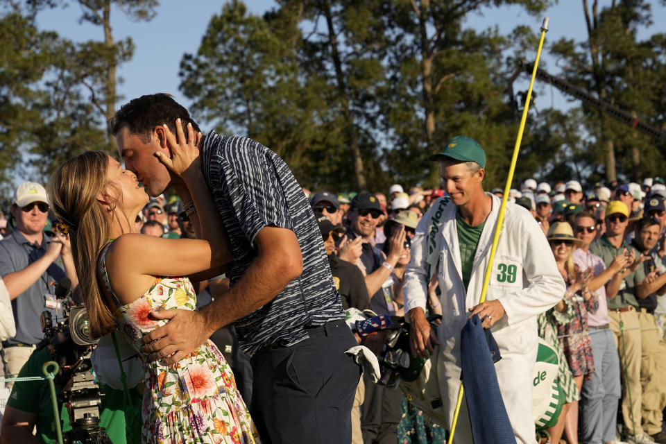Scottie Scheffler kisses his wife Meredith Scudder after winning the 86th Masters golf tournament on Sunday, April 10, 2022, in Augusta, Ga. (AP Photo/David J. Phillip)