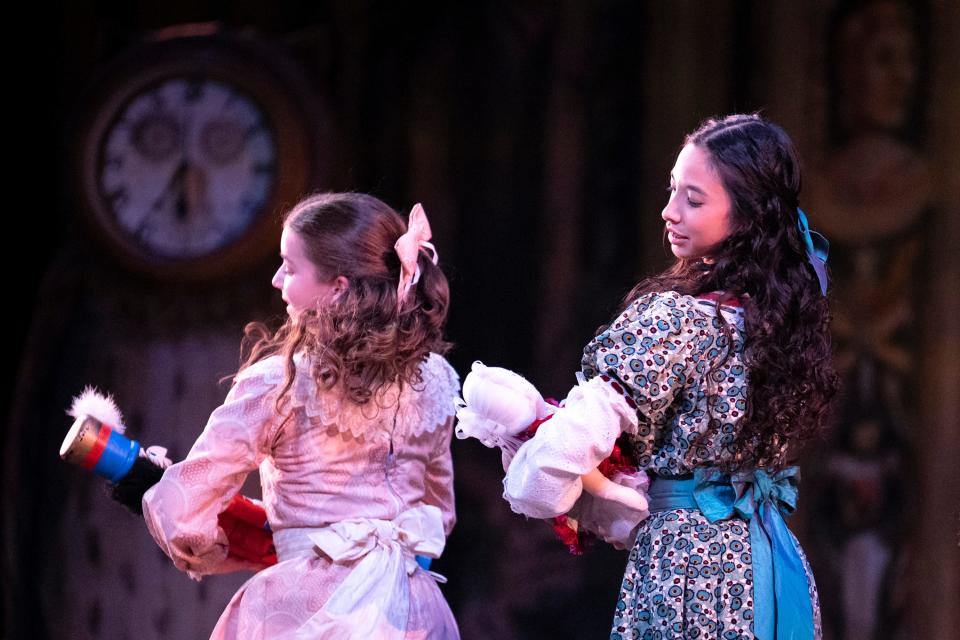 Young Clara, left, played by Chloe Steele, and a party child, played by a student in the BalletMet Academy, dance across the stage in a preview rehearsal for BalletMet’s performance of "The Nutcracker."