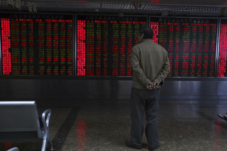 A Chinese man monitors stock prices at a brokerage in Beijing, China, Thursday, Feb. 21, 2019. Asian stock markets were little-changed Thursday following a listless day on Wall Street ahead of U.S.-Chinese negotiations aimed at ending a tariff battle. (AP Photo/Ng Han Guan)