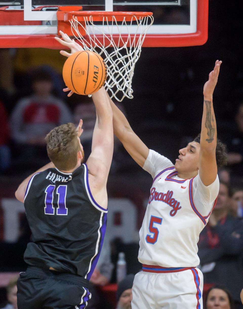 Bradley's Christian Davis, right, stops Evansville's Joshua Hughes in the first half of their Missouri Valley Conference basketball game Wednesday, Jan. 10, 2024 at Carver Arena. The Braves routed the Purple Aces 86-50.