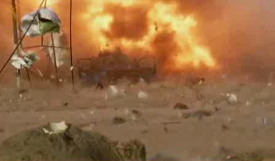 This image made from video shows a car bomb at the moment of impact, one in a series of bombs that exploded Friday, April 25, 2014 at a campaign rally for a Shiite group in Baghdad, Iraq, ahead of the country's parliamentary election. The blasts killed and wounded dozens, officials said. (AP Photo via AP video)