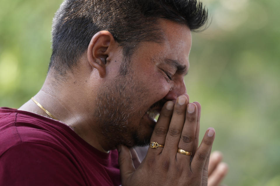 A man mourns during the cremation of a relative Rahul Bhat, who was a minority Kashmiri Hindu known as "pandits," killed on Thursday, in Jammu, India, Friday, May 13, 2022. Bhat, who was a government employee, was killed by suspected rebels inside his office in Chadoora town in the Indian portion of Kashmir. (AP Photo/Channi Anand)