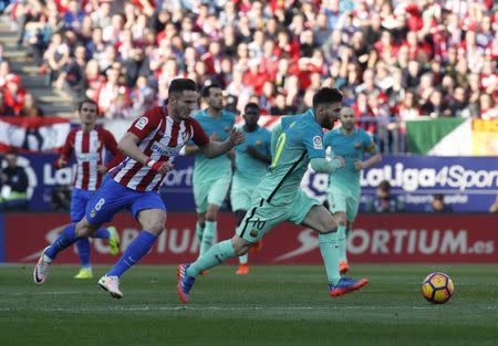 Football Soccer - Atletico Madrid v Barcelona - Spanish La Liga Santander - Vicente Calderon Stadium, Madrid, Spain, 26/02/17 Barcelona's Lionel Messi and Atletico Madrid's Saul Niguez in action. REUTERS/Juan Medina