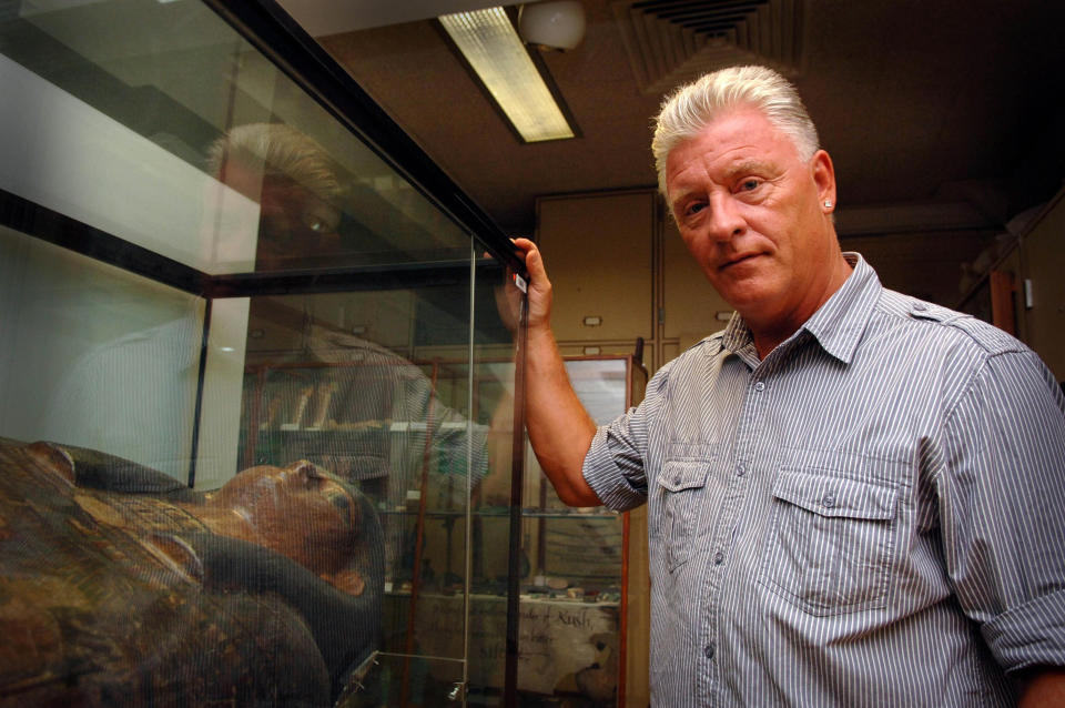 Medium and psychic Derek Acorah examines hieroglyphics on a stone tableau at the Petrie Museum of Egyptian Archaeology in central London.   (Photo by Joel Ryan - PA Images/PA Images via Getty Images)