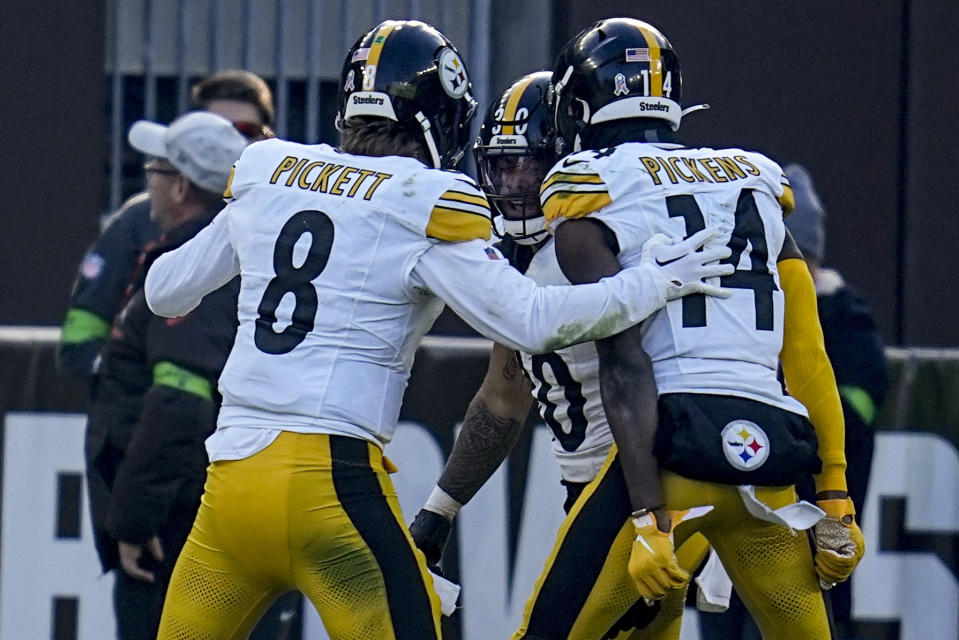 Pittsburgh Steelers running back Jaylen Warren (30) celebrates his touchdown with quarterback Kenny Pickett (8) during the second half of an NFL football game against the Cleveland Browns, Sunday, Nov. 19, 2023, in Cleveland. (AP Photo/Sue Ogrocki)