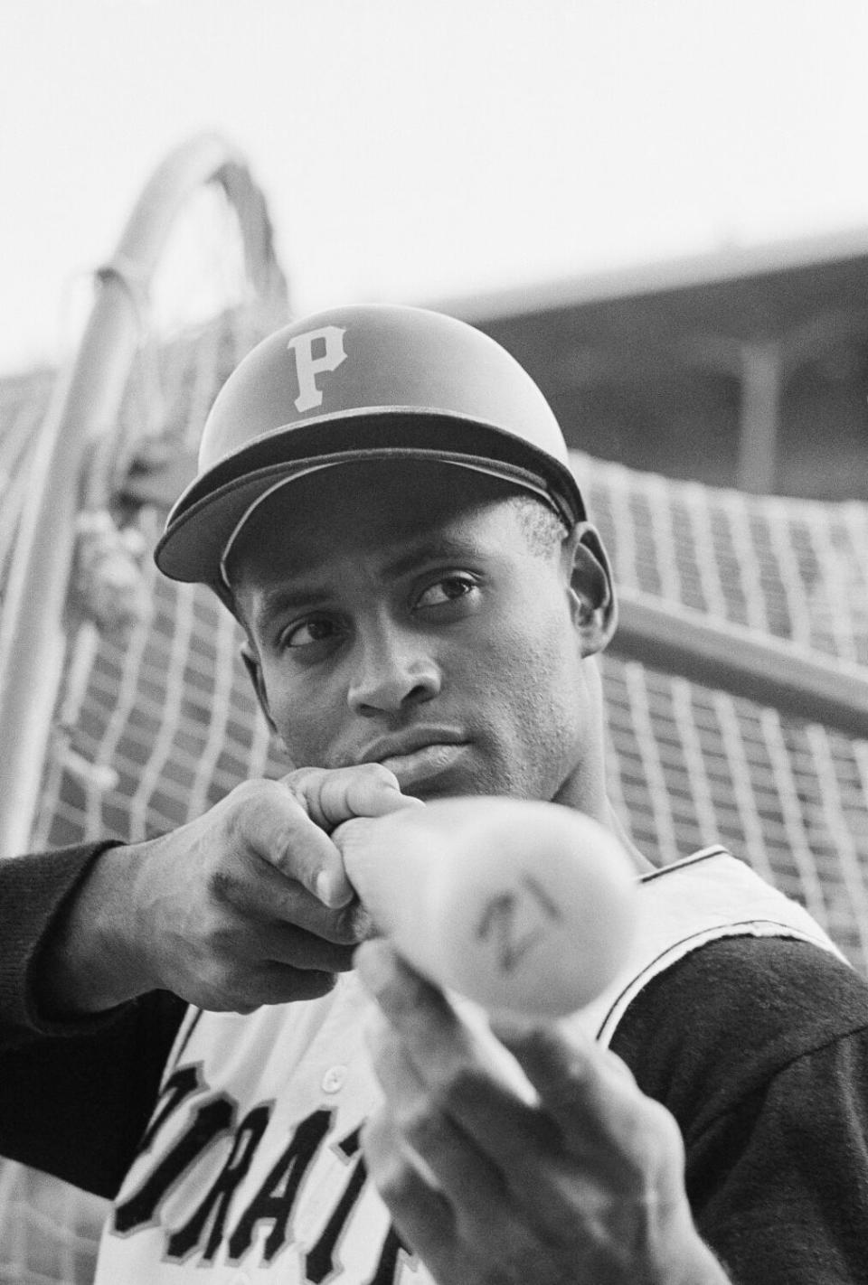 Roberto Clemente of the Pittsburgh, Prates Baseball team looks down a bat