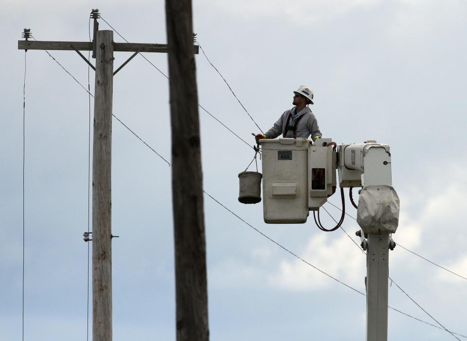 A utility crew works on a power line in Middletown.